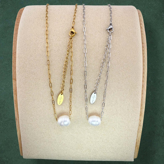 Floating baroque pearl necklaces on gold and silver paperclip chains by Aking Sinta. Each handmade necklace features a minimalist link design, adjustable extender, and signature brand tag