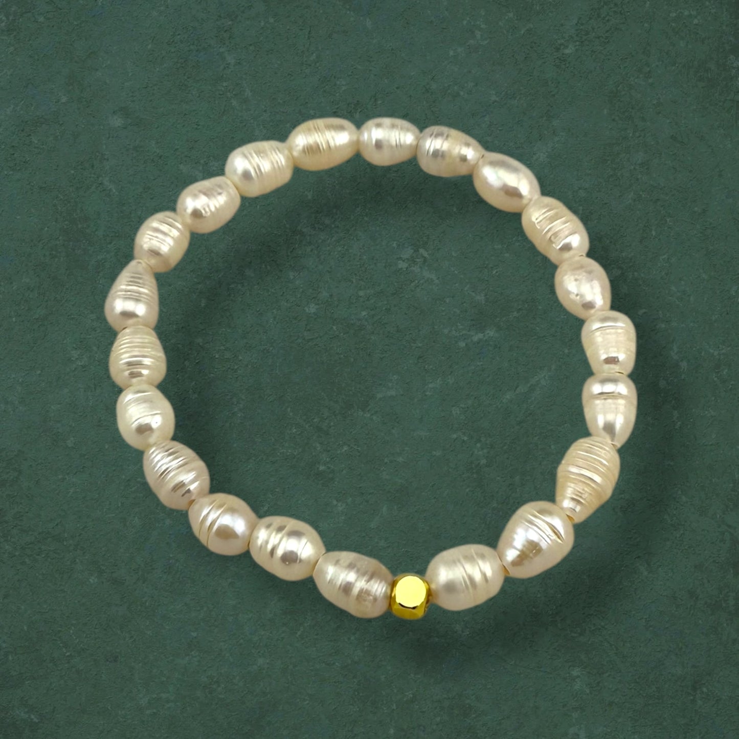 Aking Sinta Freshwater Pearl Stretch Bracelet with white beads, plain variant with no charm, displayed on dark green background, highlighting natural stone beads and stretch design