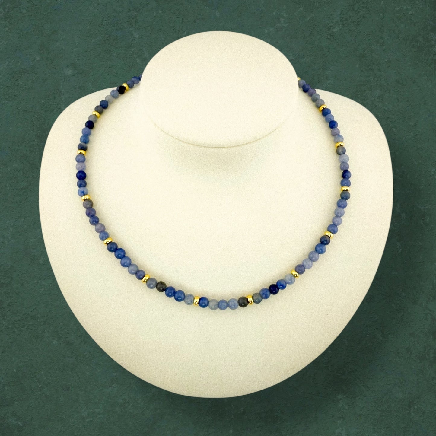 A plain Aking Sinta Blue Aventurine beaded necklace without a charm, draped on a white jewelry display bust; the soft blue gemstone beads show a natural, subtle shimmer.