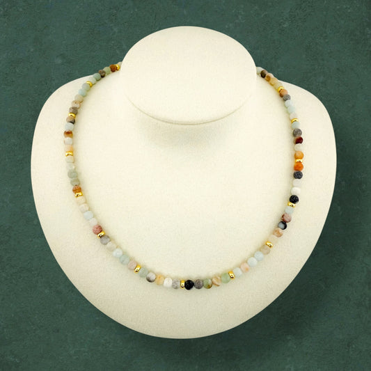 A plain Aking Sinta Flower Amazonite beaded necklace without a charm, displayed on a white jewelry bust; featuring cream, light blue, and speckled green beads with small gold bead accents.