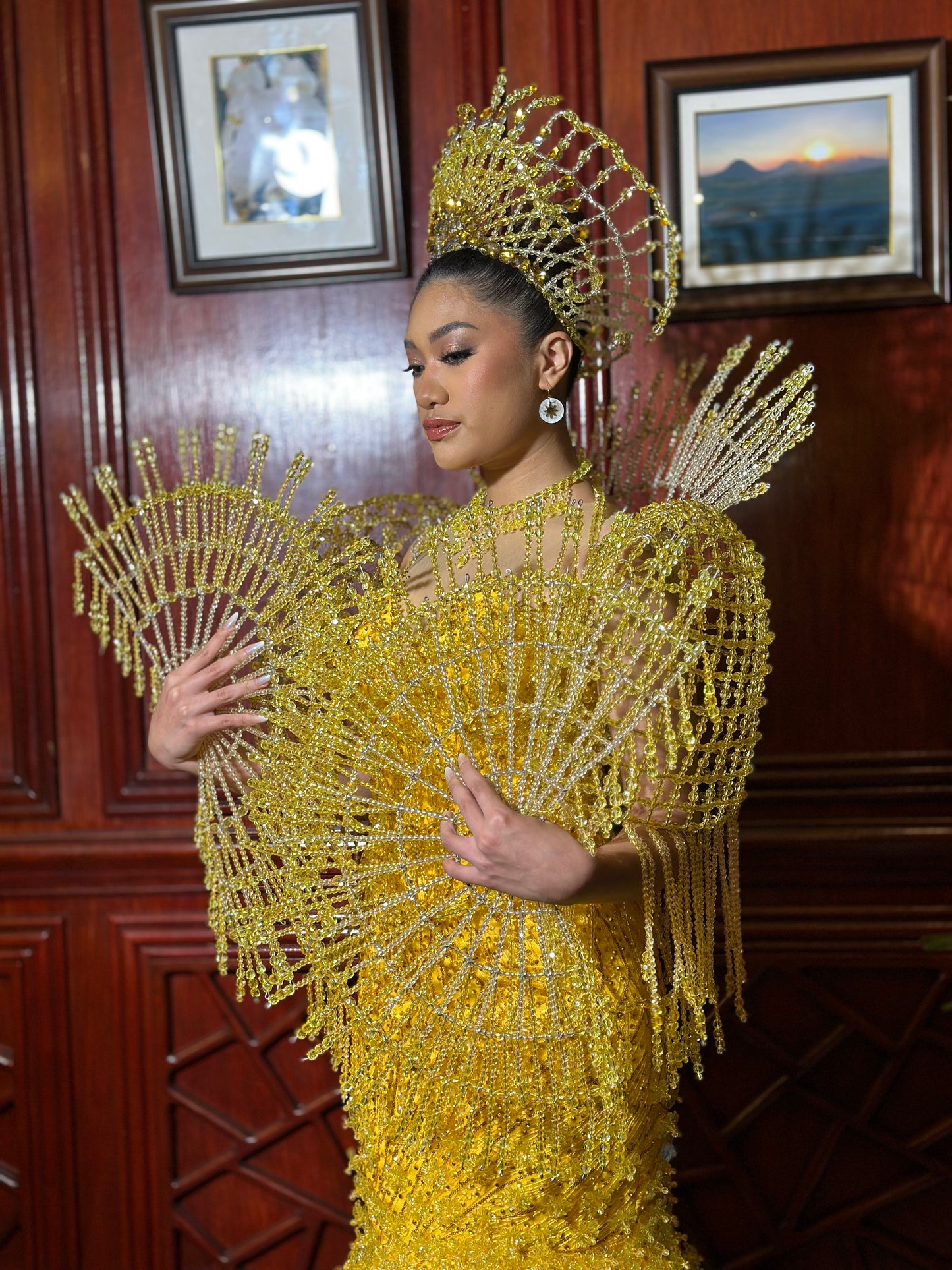 Pageant model wearing Araw and Capiz Shell hoop earrings, highlighting Filipino craftsmanship and radiant gold sun charm elegance