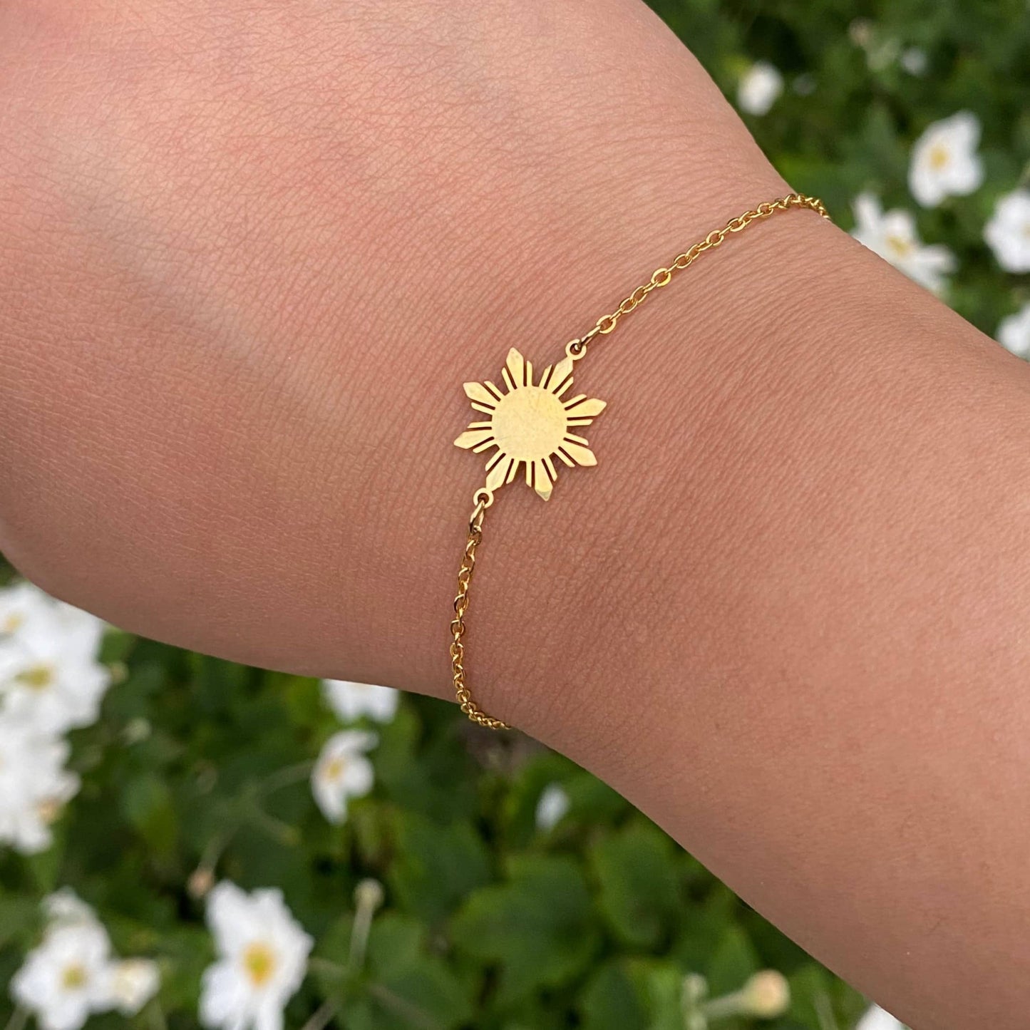 Araw minimalist bracelet with Philippine sun charm in 18K gold plated stainless steel, worn on hand as modern Filipino jewelry