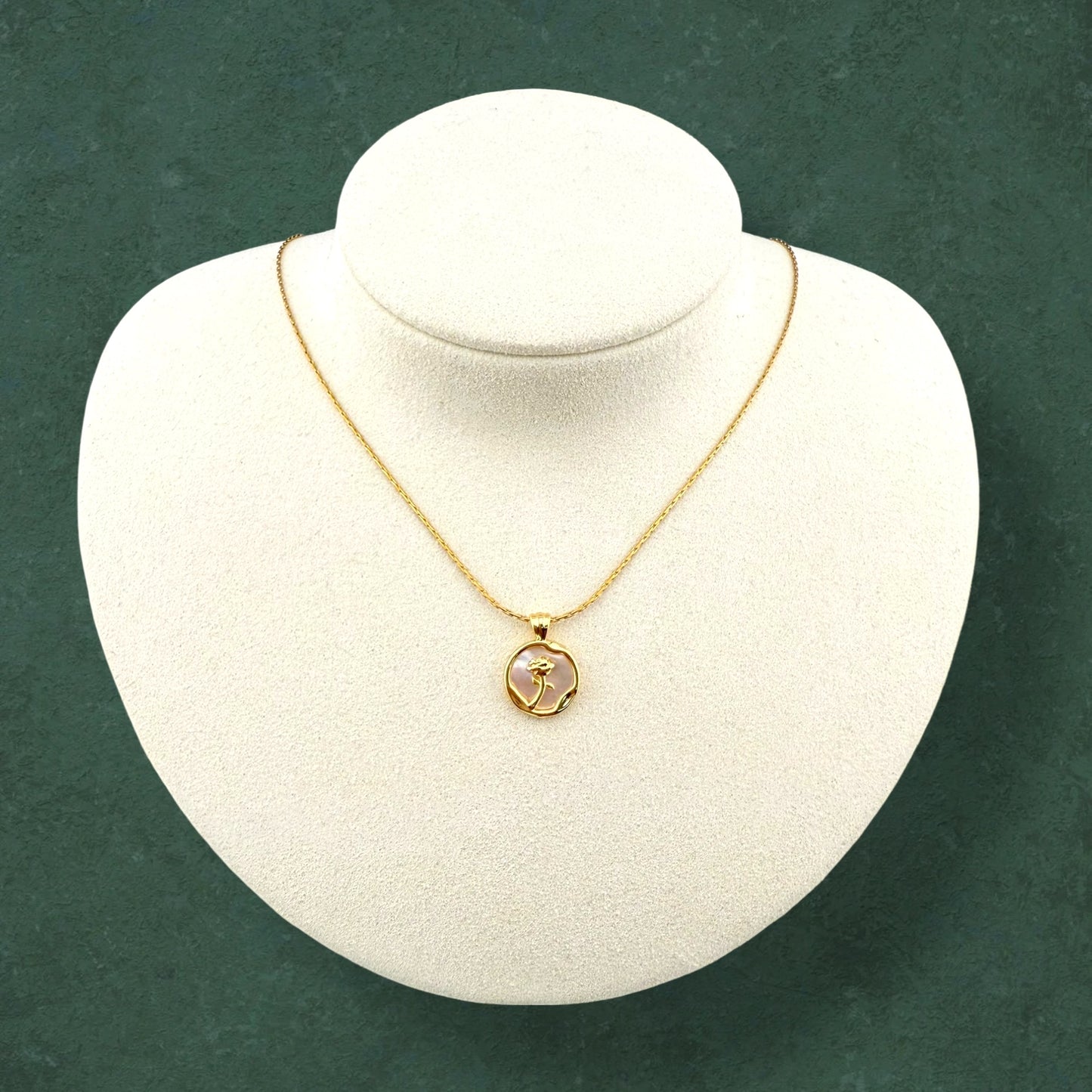 Rose and Mother of Pearl necklace displayed on stand, highlighting delicate floral pendant and lustrous pearl craftsmanship