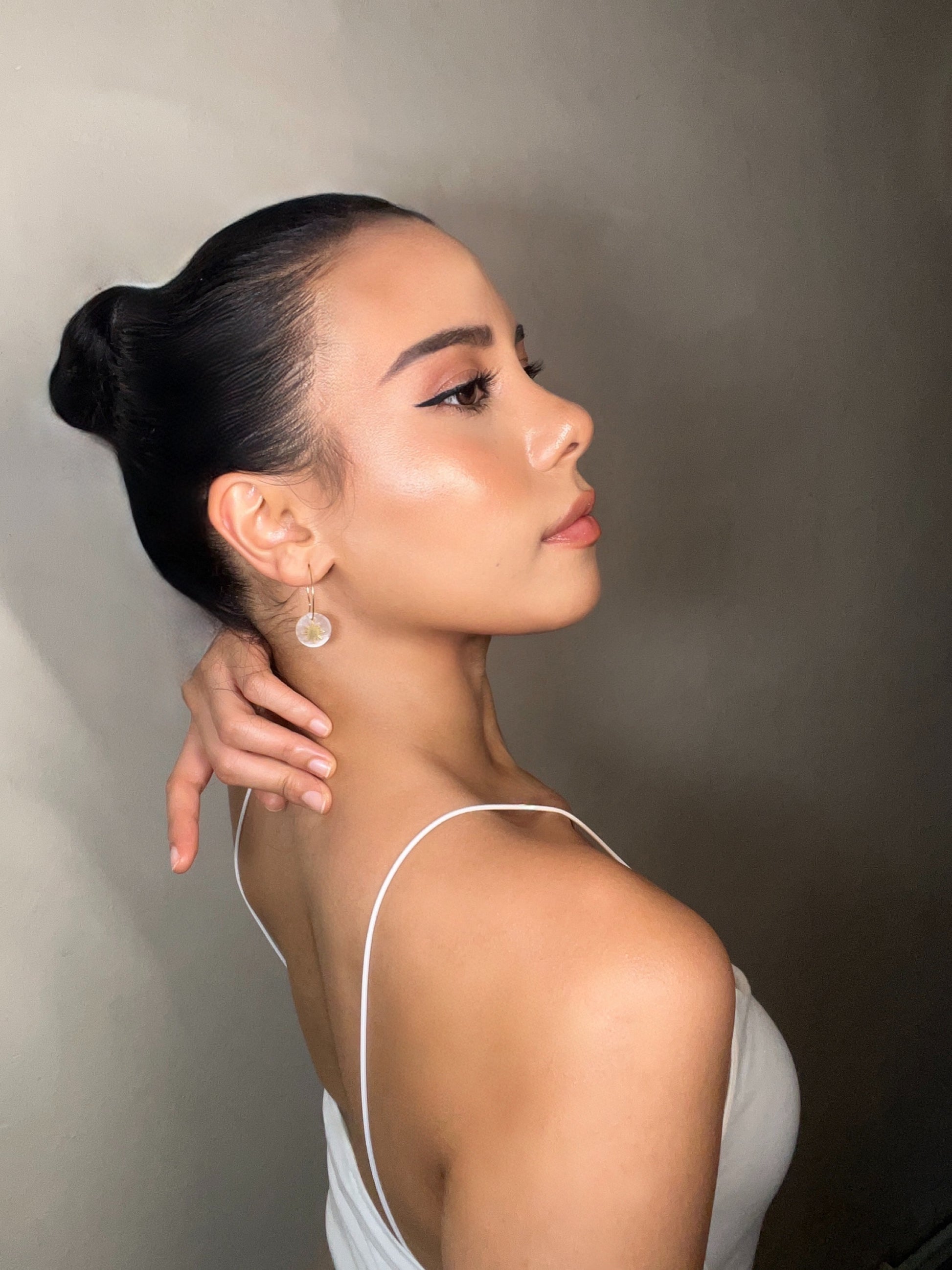 Aking Sinta Araw and Capiz Shell Dainty Hoop Earrings worn by model with hand placed at lower back of neck, showcasing earrings and highlighting lightweight, Philippine-inspired design