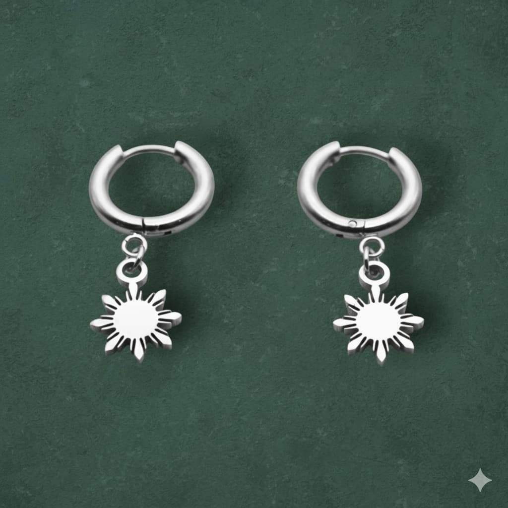 Aking Sinta Araw Charm Huggies in silver inspired by the 8-ray sun on clean dark green background