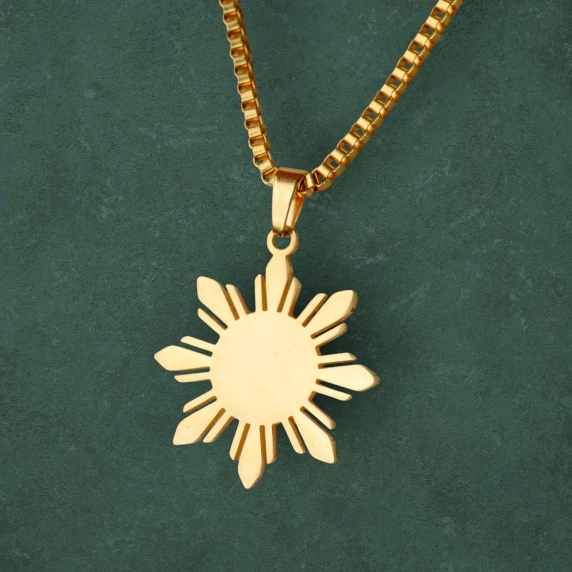 Aking Sinta Araw Chunky Box Chain Necklace in gold close-up on dark green background