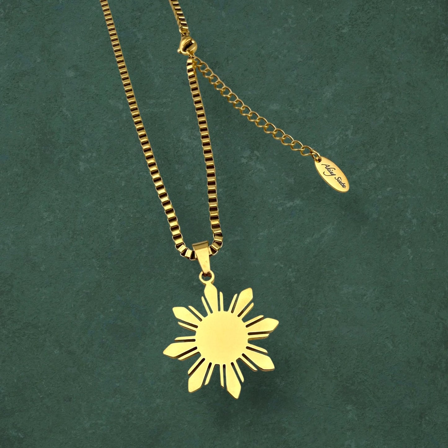 Aking Sinta Araw Chunky Box Chain Necklace in gold close-up on dark green marble background