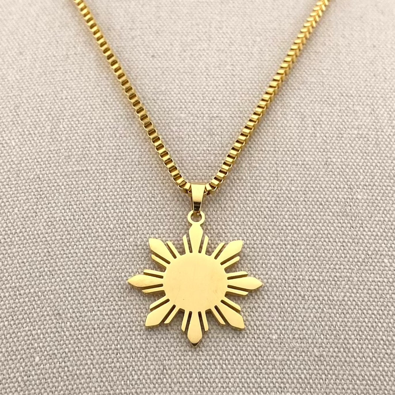 Aking Sinta Araw Chunky Box Chain Necklace in gold close-up on white woven background