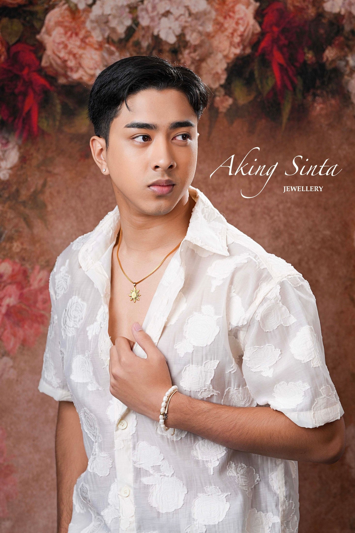 Aking Sinta Araw Chunky Box Chain Necklace in gold worn by man with short hair in half-open short-sleeve polo, looking right