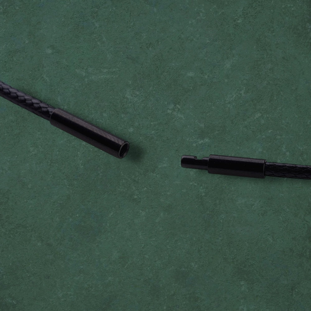 Close-up of black cord of Aking Sinta Araw Cord Necklace displayed on dark green background, highlighting adjustable cord design and Philippine-inspired craftsmanship”