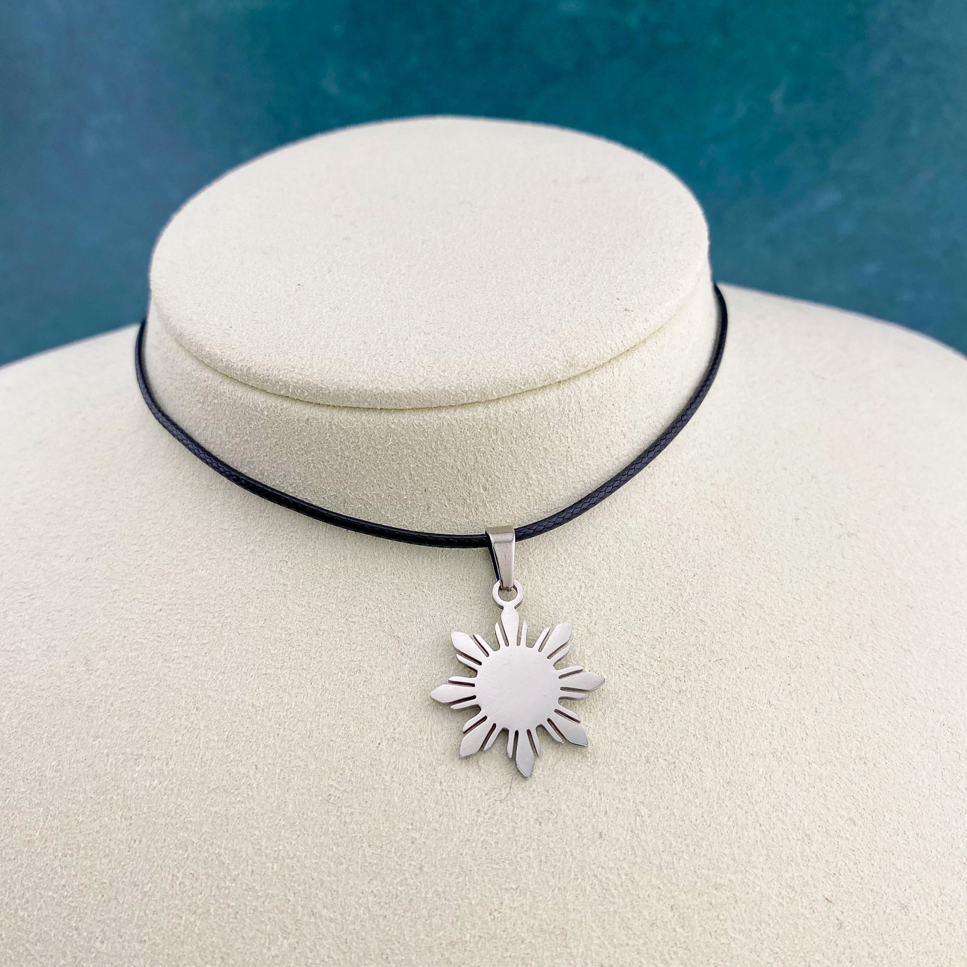 Aking Sinta Araw Cord Necklace with black cord and silver Araw sun charm displayed on neck-shaped jewellery holder, highlighting adjustable cord design and Philippine-inspired craftsmanship
