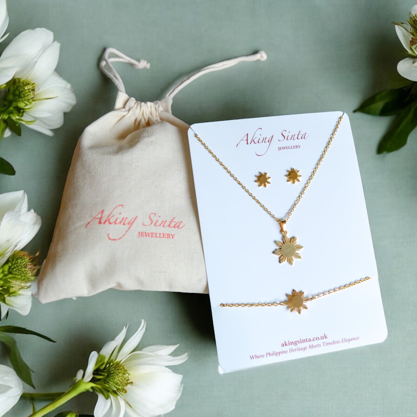 Aking Sinta Araw jewellery set in gold displayed on branded cardboard jewellery holder with drawstring pouch, highlighting Philippine-inspired gift packaging