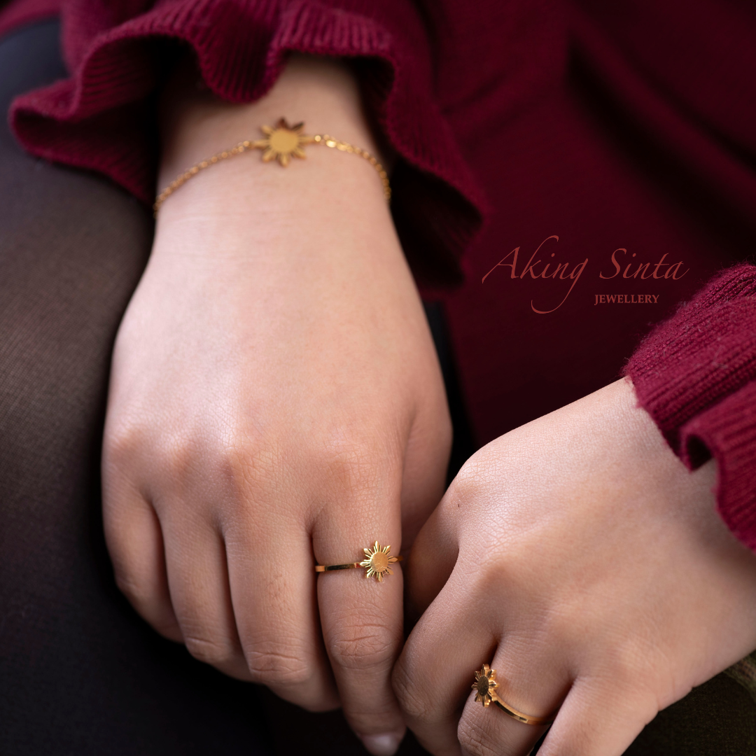 Aking Sinta Araw Adjustable Ring and Araw Friendship Bracelet worn by woman in red dress, showcasing 8-ray sun design and Philippine-inspired jewellery