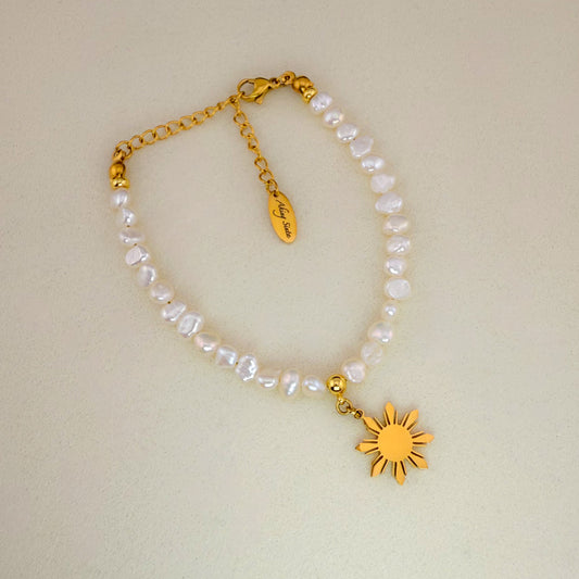 Aking Sinta Baroque pearl bracelet with a gold Philippine 'Araw' sun charm, displayed on a minimalist white background.