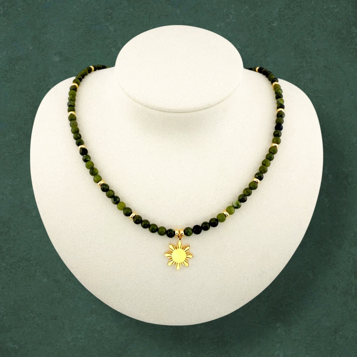 Aking Sinta Canadian Jade beaded necklace on a white display bust; featuring deep forest-green opaque gemstones accented with polished gold beads throughout the strand and a central gold 8-ray Araw sun charm; no extender.