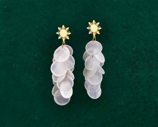 Aking Sinta Cascading Capiz Shell Araw Stud Earrings gold variant displayed on dark green background, highlighting lightweight design and Philippine-inspired craftsmanship