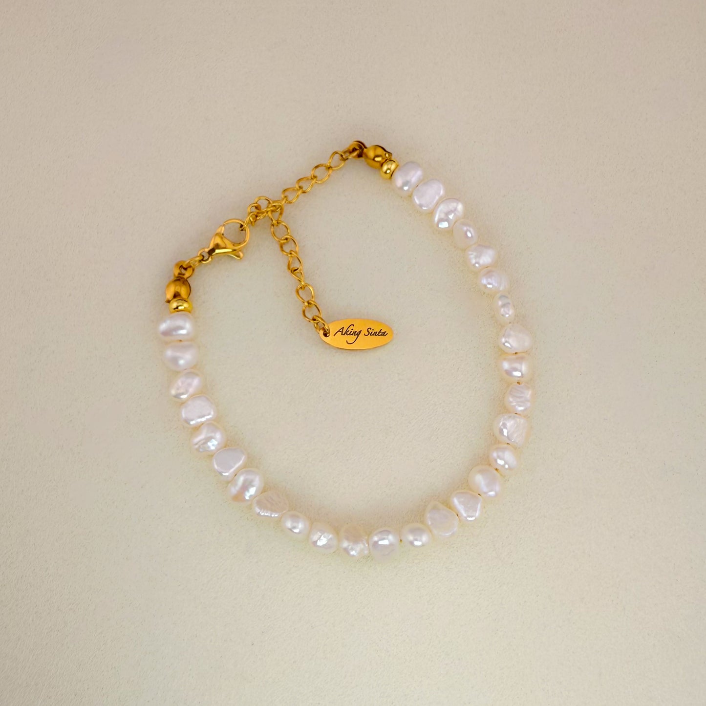 Aking Sinta statement bracelet featuring a full strand of large, organic Baroque pearls on a clean white background.