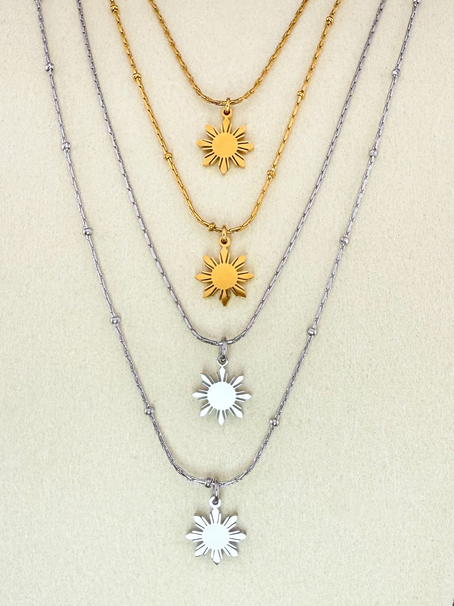 Aking Sinta Dainty Araw Necklace in gold and silver on white background, showcasing 8-ray sun design, Philippine-inspired jewellery with subtle heritage