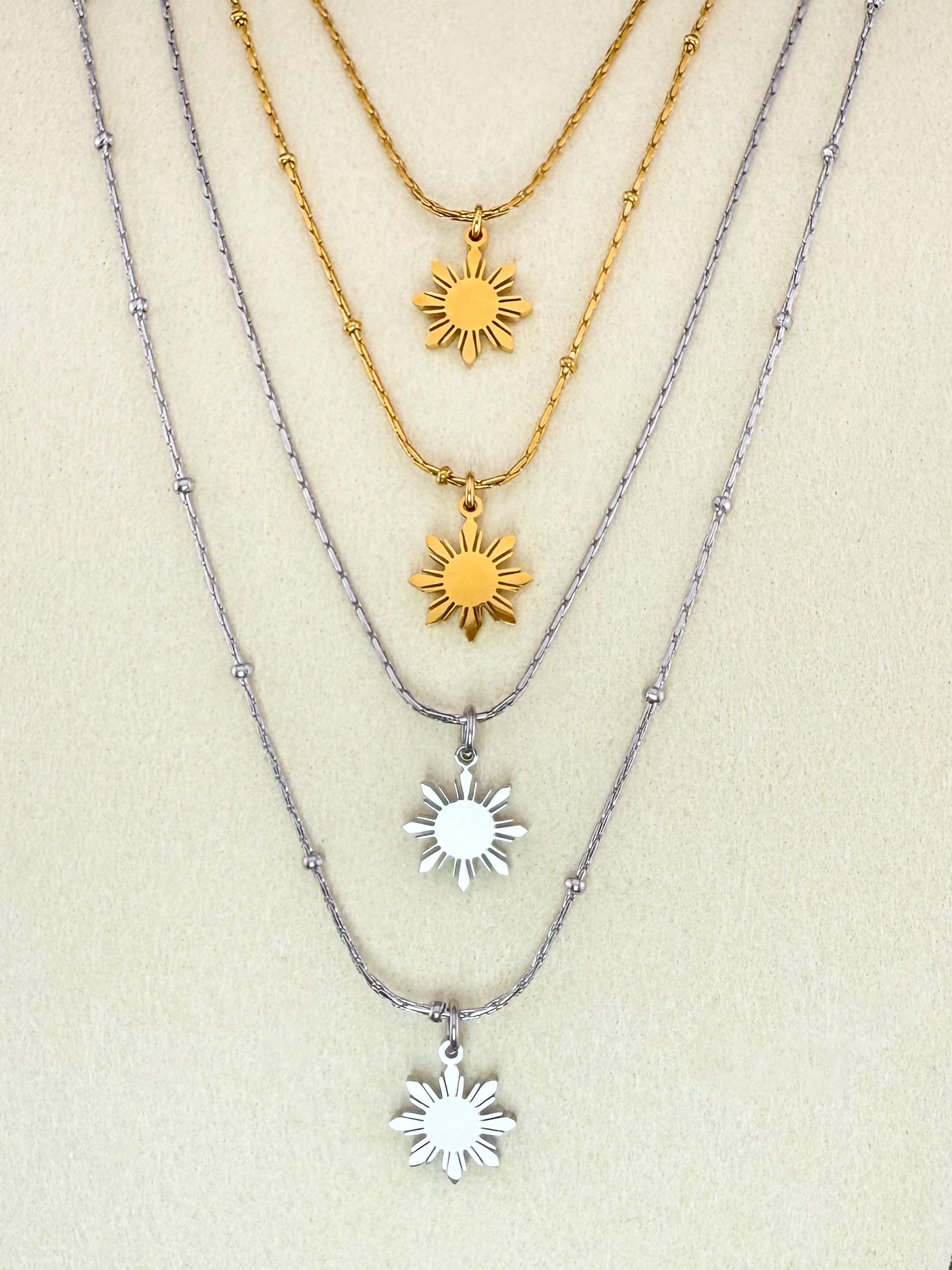 Aking Sinta Dainty Araw Necklace in gold and silver on white background, showcasing 8-ray sun design, Philippine-inspired jewellery with subtle heritage