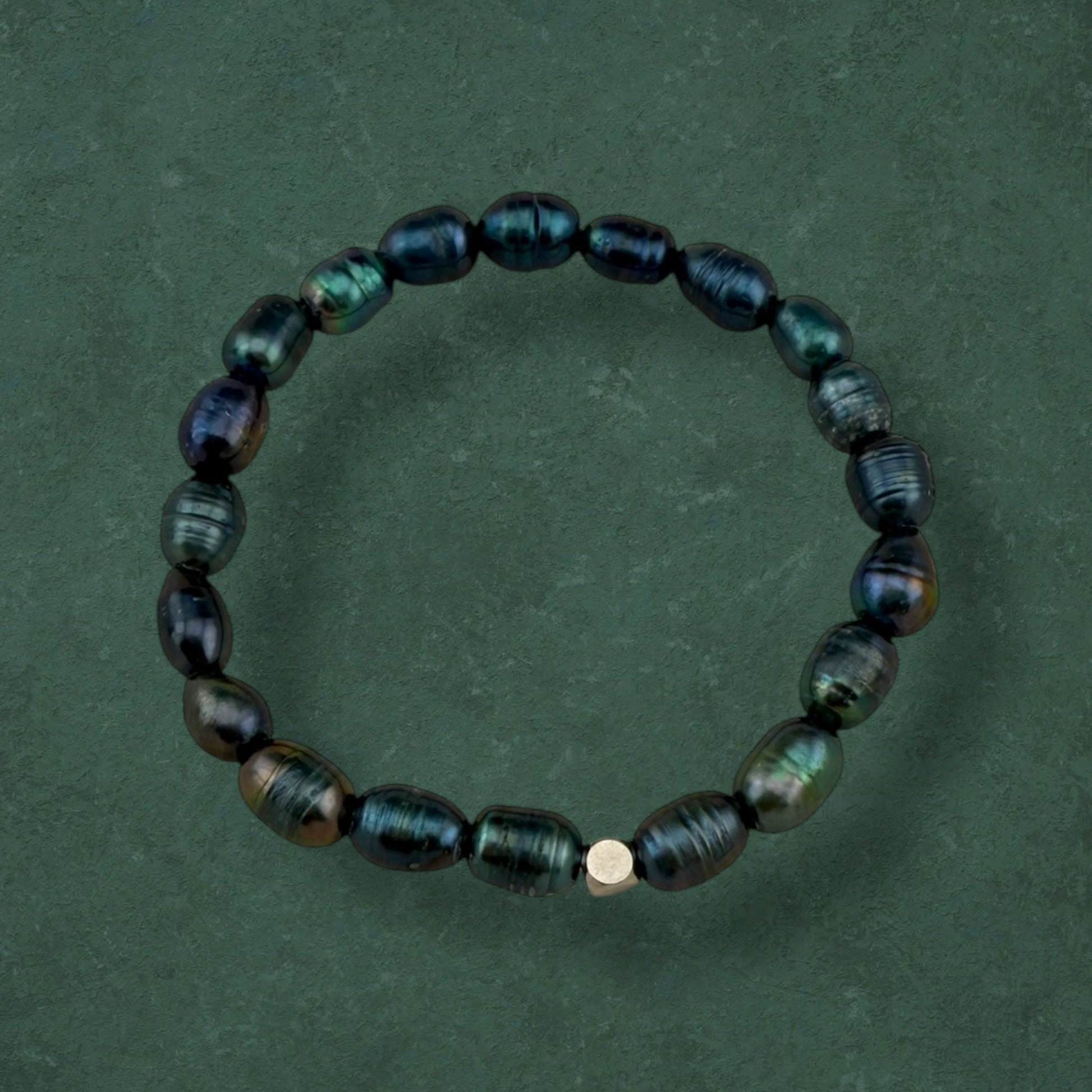 Aking Sinta Freshwater Pearl Stretch Bracelet with dark blue beads, plain variant with no charm, displayed on dark green background, highlighting natural stone beads and stretch design