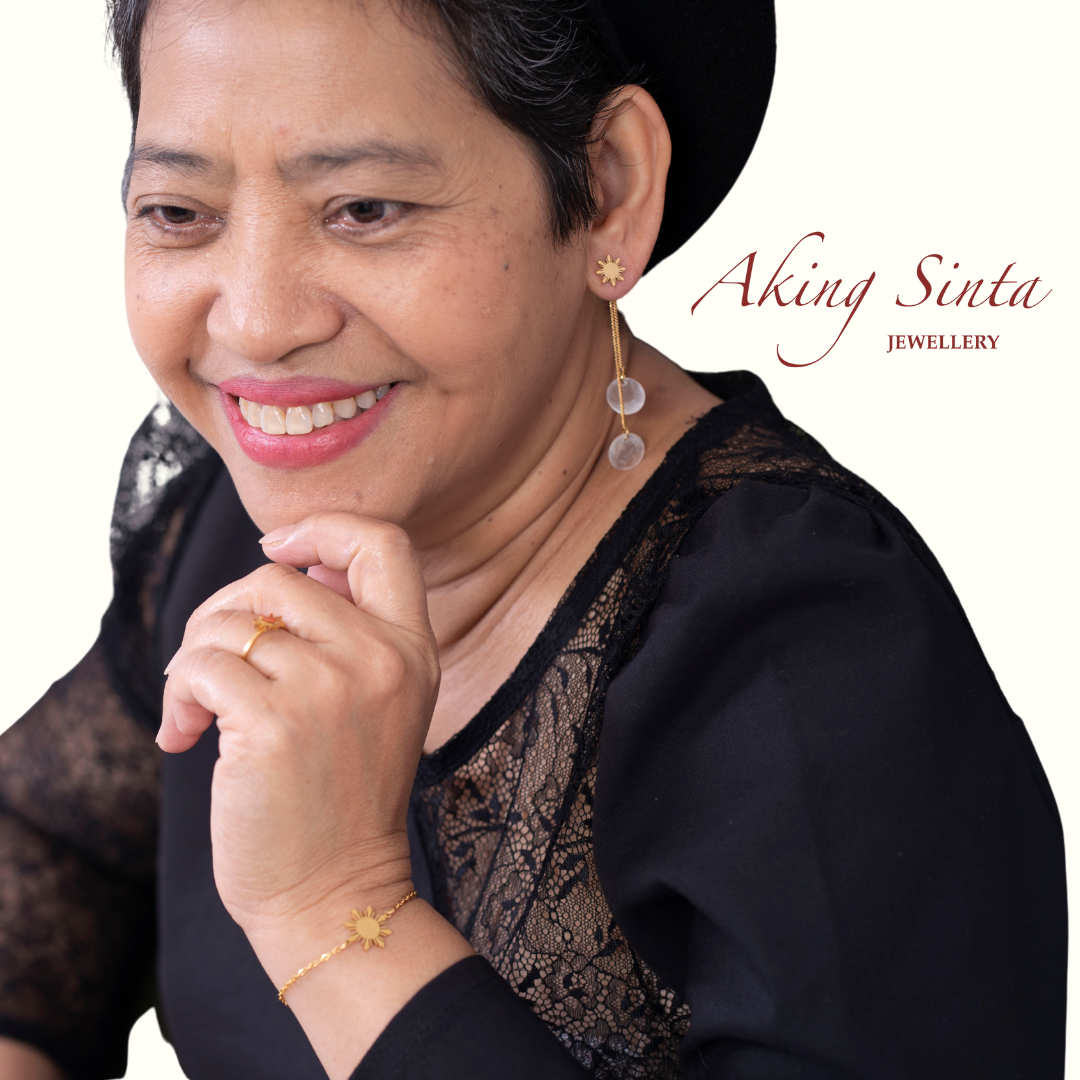 Aking Sinta full Araw jewellery set in gold worn by mother of the founder in black dress and black hat, featuring studs, necklace, bracelet and adjustable ring with 8-ray sun moti
