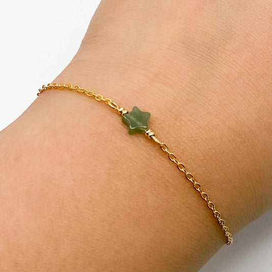 An Aking Sinta product photograph showcasing the dainty green aventurine star bracelet worn on a wrist against a plain white background. The delicate jewelry piece features a small, star-shaped green aventurine gemstone charm centered on a fine gold link chain with tiny gold accent beads on either side.