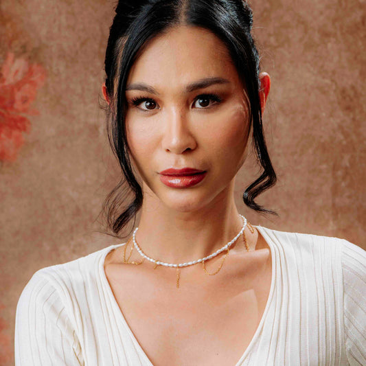 Model wearing Kacey’s Asymmetrical Fringe Rice Pearl Necklace by Aking Sinta, showing the unique cascading pearl fringe detail and its iridescent luster against the skin.