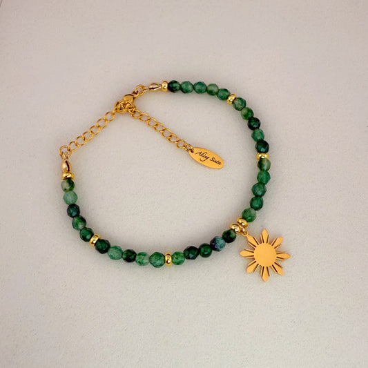 Aking Sinta Malaysian Jade beaded bracelet featuring vibrant, uniform green gemstone beads and a polished gold 8-ray Araw sun charm; displayed on a crisp white background