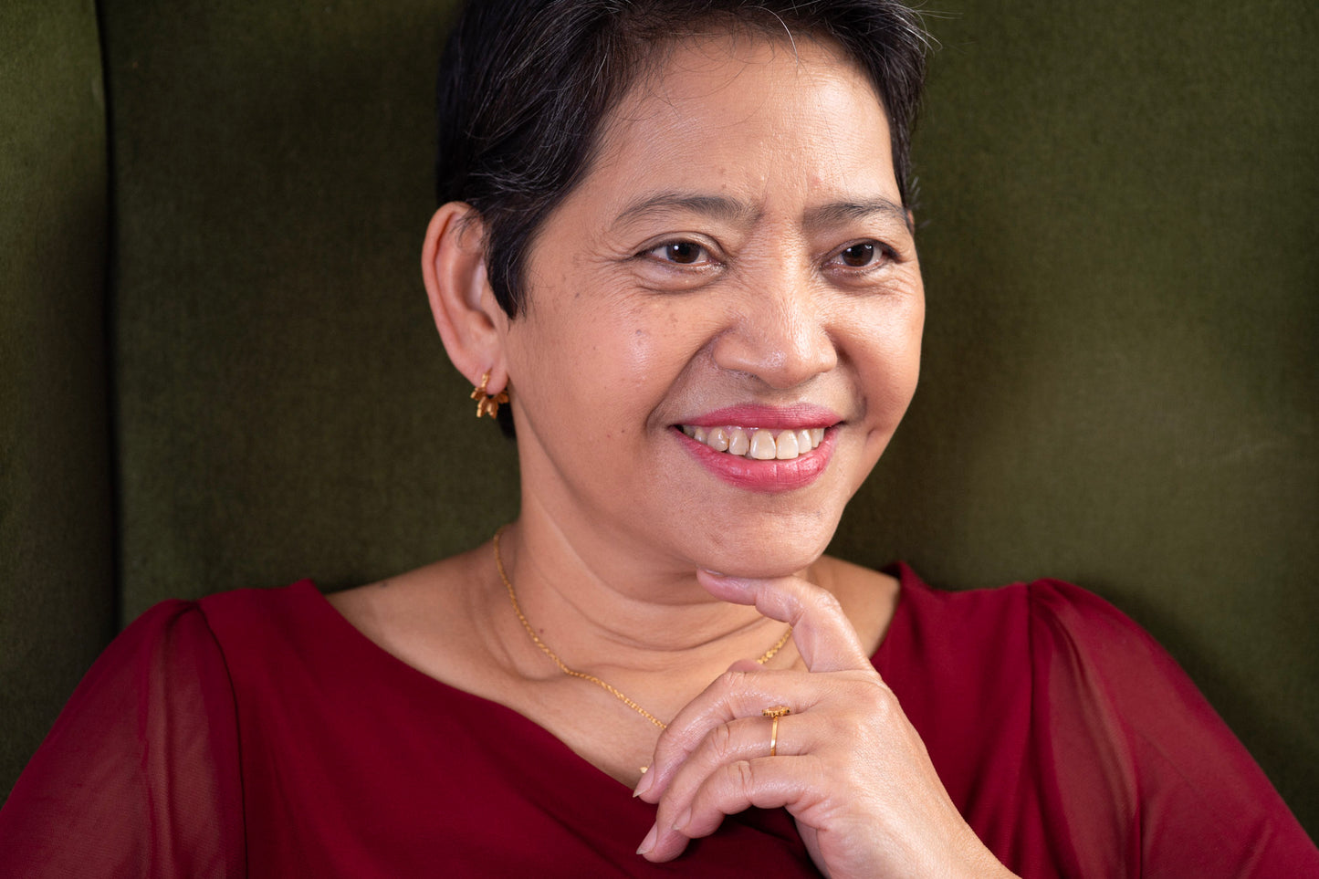 Close up of the founder's mother wearing the Araw gold 5-ray sun hoop earrings, demonstrating a timeless and elegant jewelry style for all ages