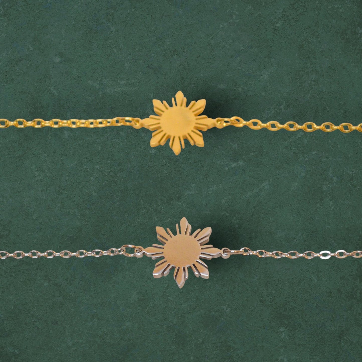 Araw minimalist sun bracelets in gold and silver variants displayed on a vibrant green background, featuring delicate chains and celestial sunburst pendants.