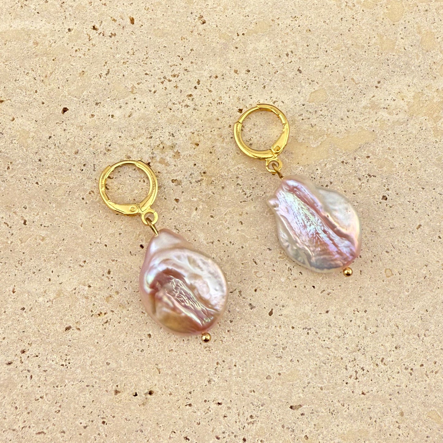 Purple Keshi Pearl Huggie Earrings in gold plated stainless steel featuring irregular freshwater pearls, elegant minimalist jewellery displayed on neutral background