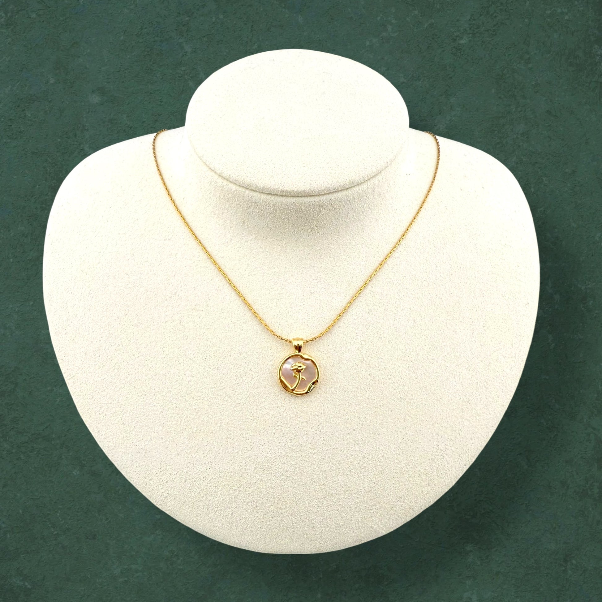 Rose and Mother of Pearl necklace displayed on stand, highlighting delicate floral pendant and lustrous pearl craftsmanship